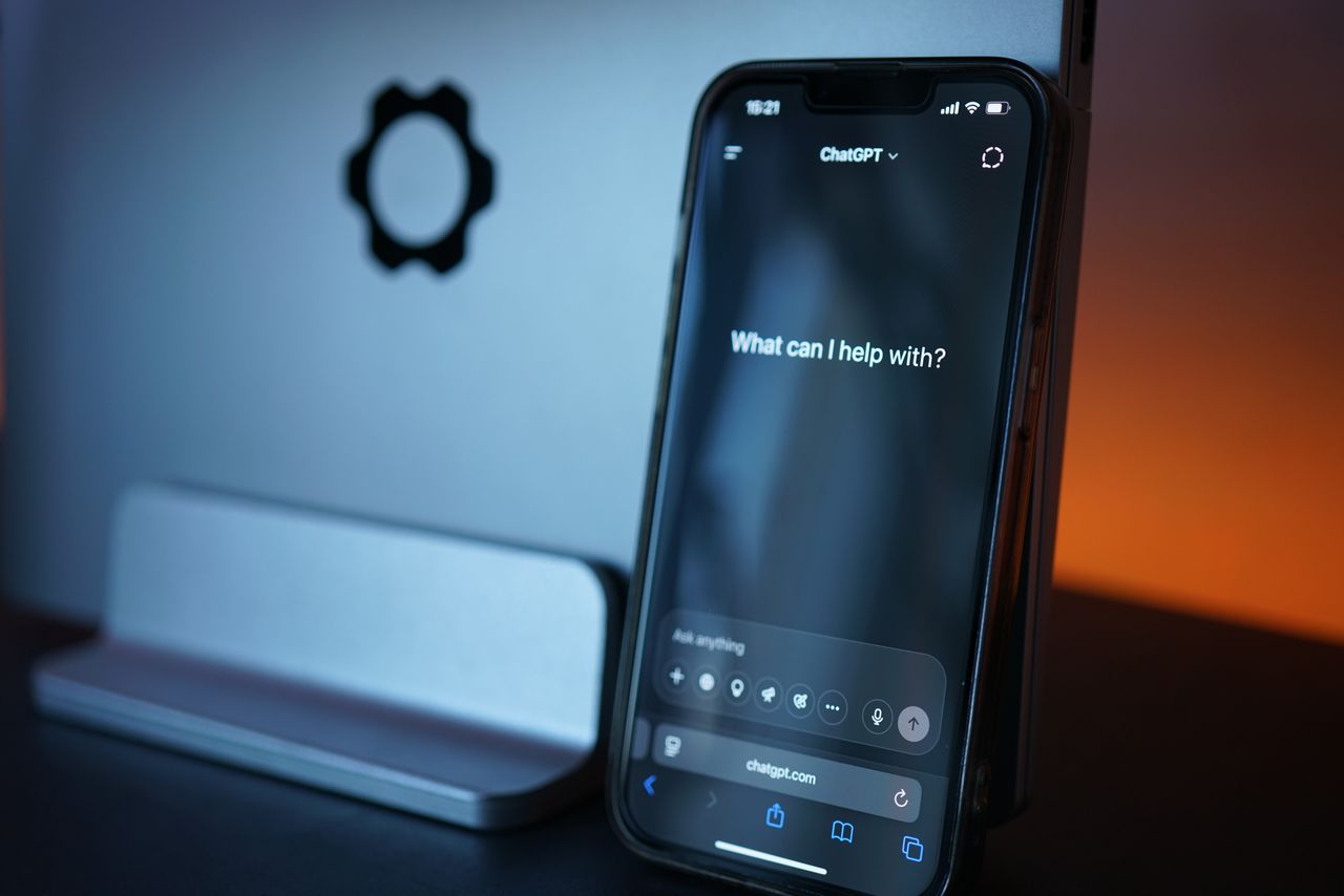 services-02 Close-up of a smartphone with AI chat interface, showcasing advanced technology in a sleek design.