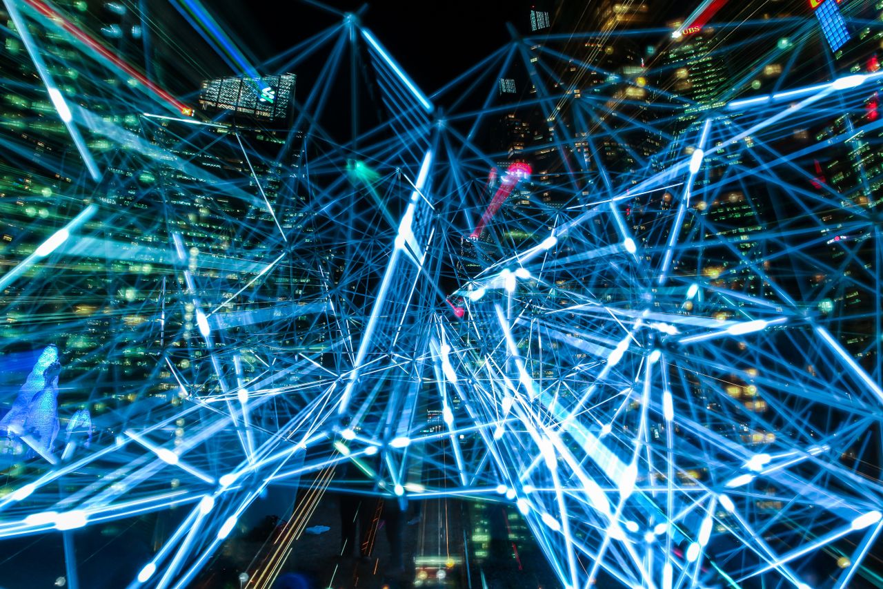 who-we-are Dynamic urban scene showcasing interconnected light trails representing digital communication networks.