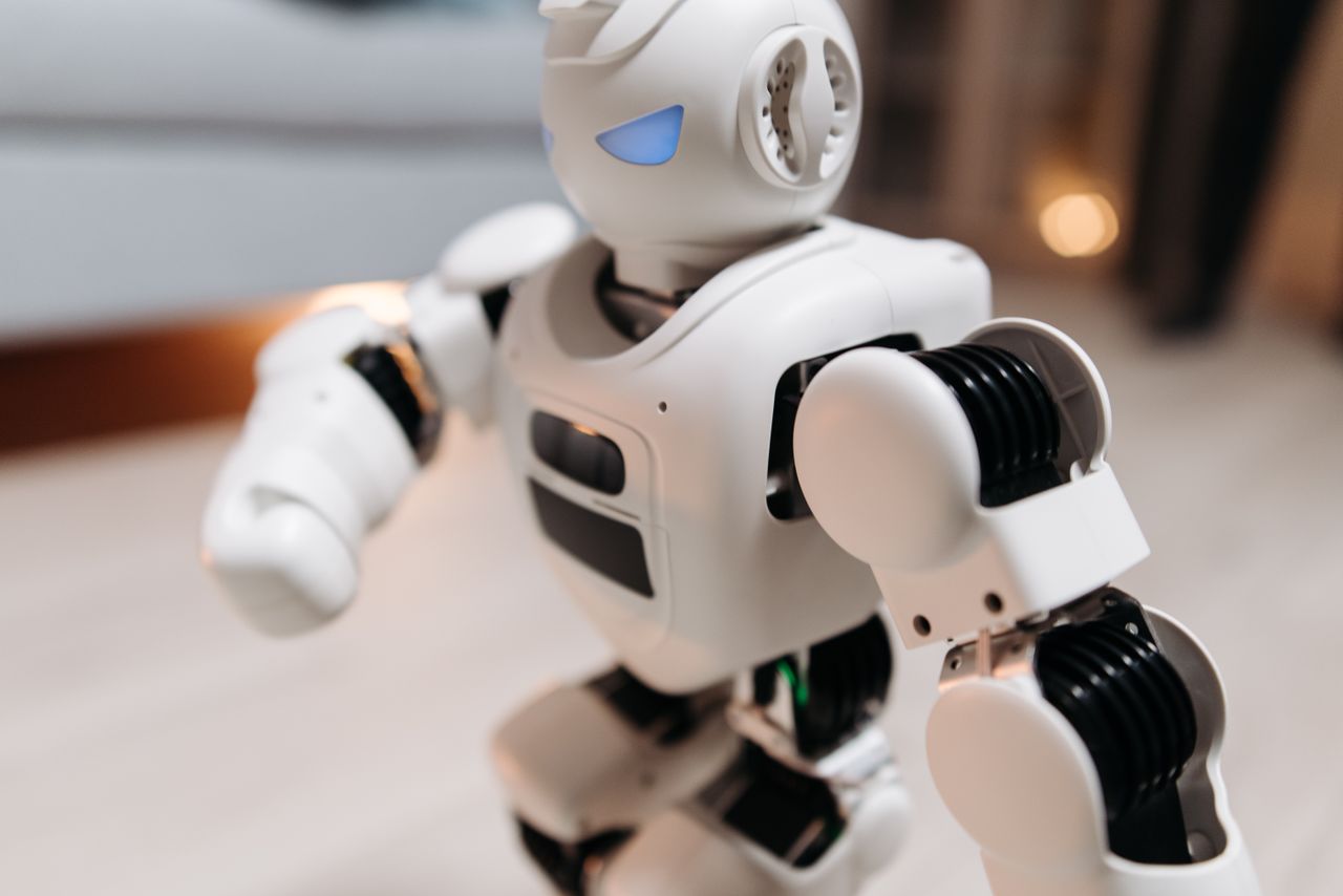 Crafting Captivating Headlines: Your awesome post title goes here Close-up of a futuristic toy robot with blue eyes, showcasing modern technology indoors.